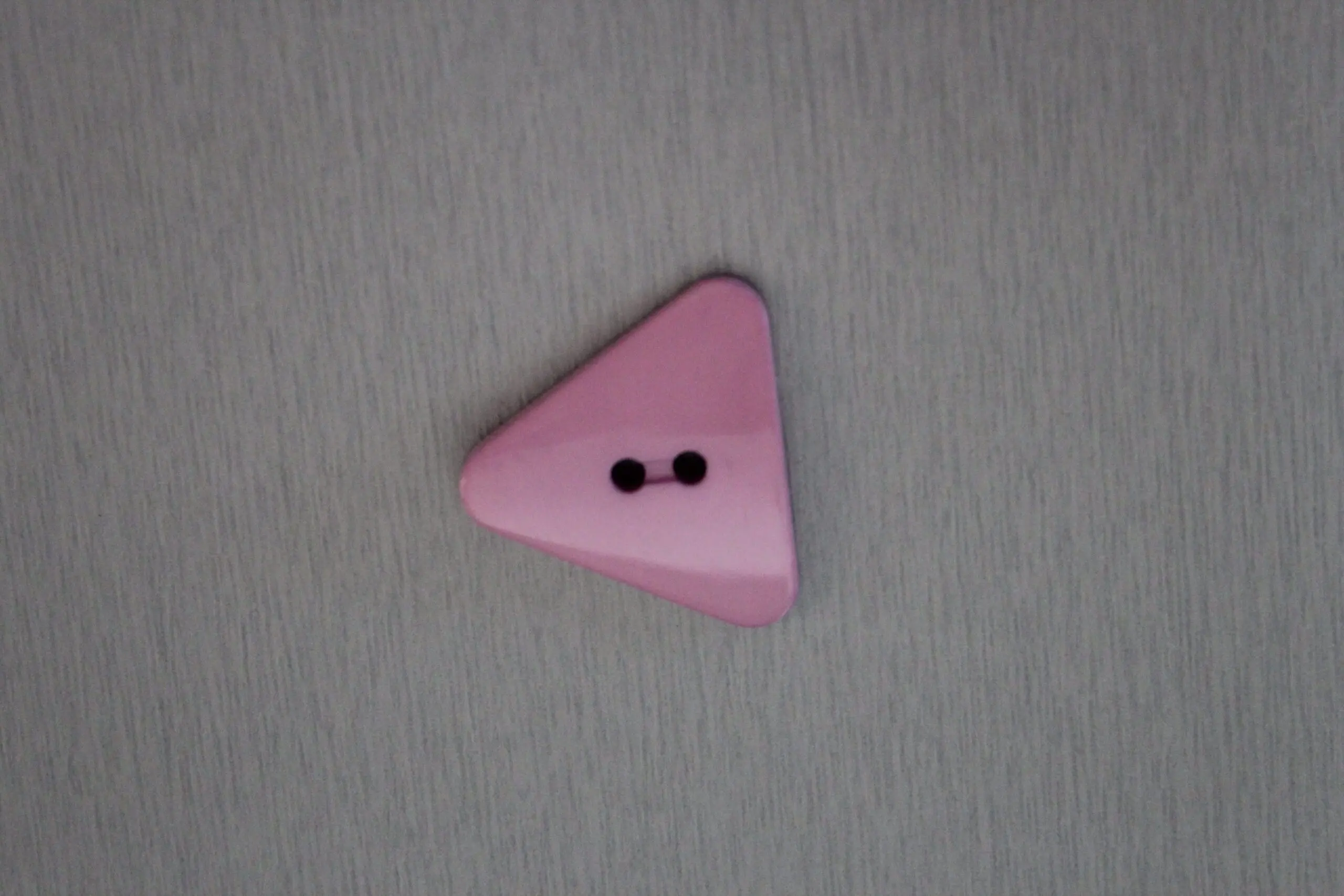 Trekantig Knapp 25 mm Ljuslila - En ljuslila trekantig knapp i storleken 25 mm.
